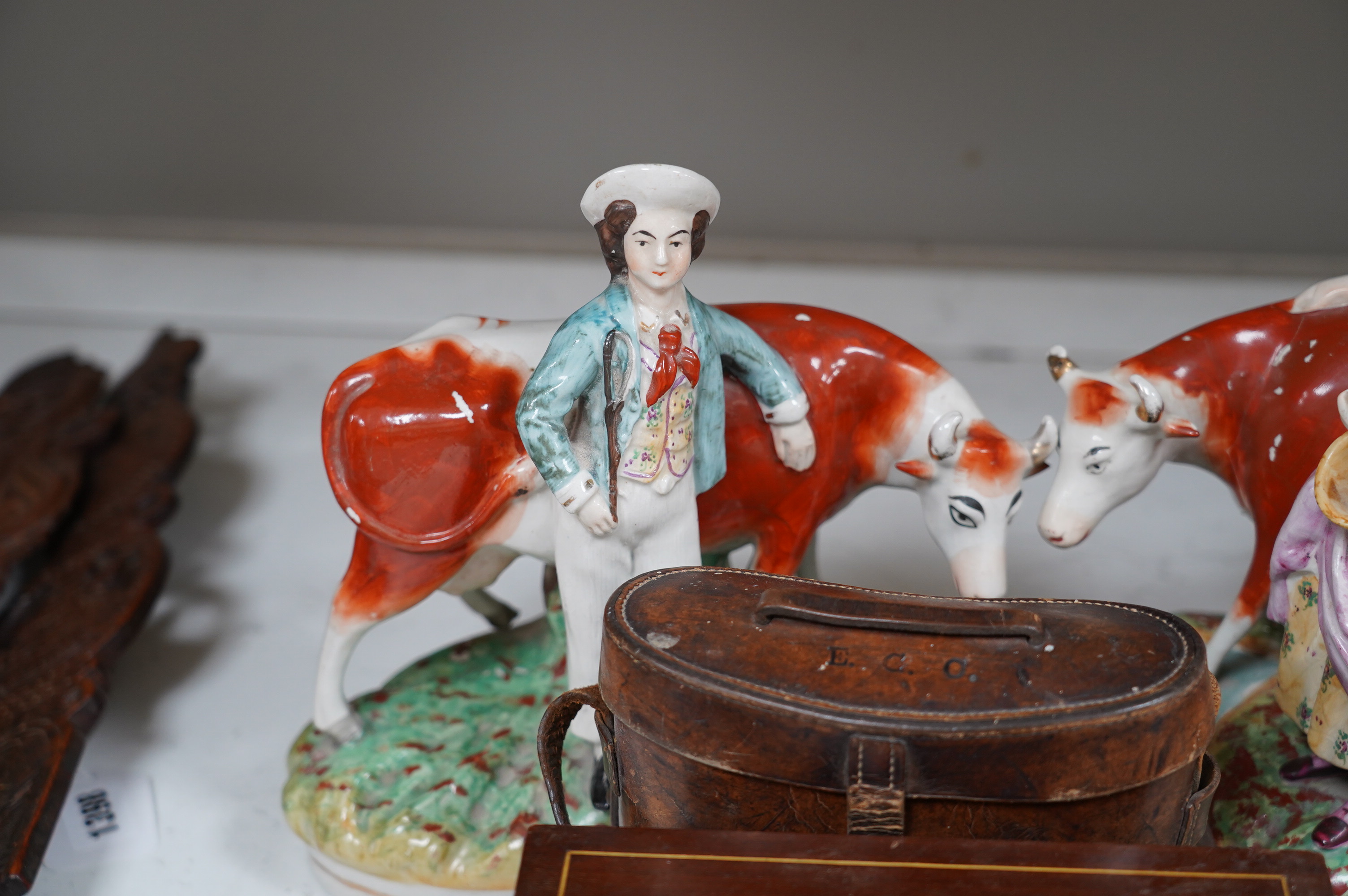 A pair of Staffordshire cow groups, two boxes and a cased pair of binoculars. Condition - fair